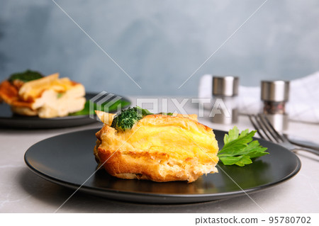 Tasty broccoli casserole served on grey table Tasty broccoli casserole served on grey table 95780702