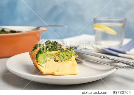 Tasty broccoli casserole served on grey marble table Tasty broccoli casserole served on grey marble table 95780704