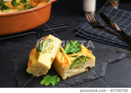 Tasty broccoli casserole served on black table Tasty broccoli casserole served on black table 95780706