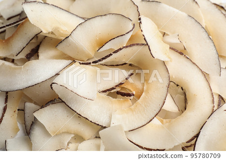 Delicious fresh coconut chips as background, closeup Delicious fresh coconut chips as background, closeup 95780709