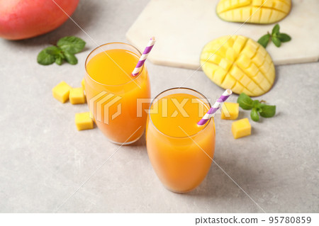 Fresh delicious mango drink on light table Fresh delicious mango drink on light table 95780859