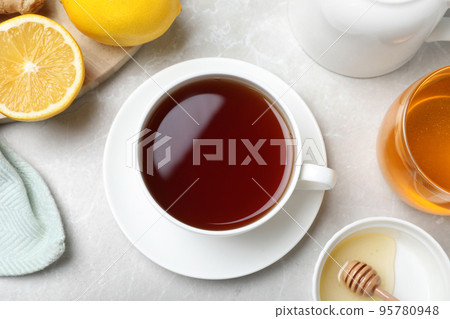 Flat lay composition of tea with honey on light grey marble table 95780948