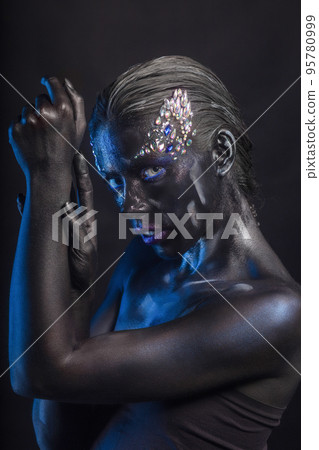 Cute woman with creative makeup on her face Cute woman with creative makeup on her face 95780999