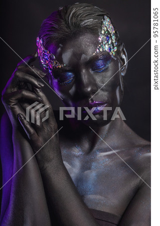 Attractive woman with creative makeup on her face 95781065