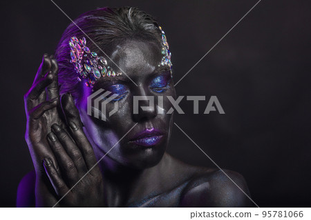 Nice woman with creative makeup on her face Nice woman with creative makeup on her face 95781066