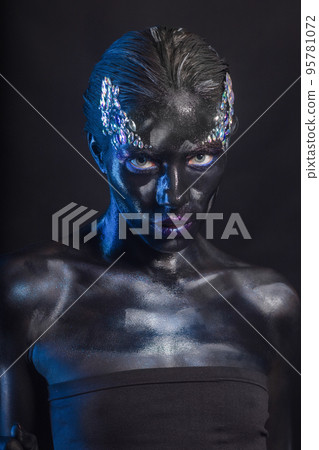 Attractive young woman with creative makeup on her face 95781072