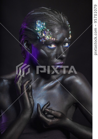 Attractive brunette with art makeup on face 95781079