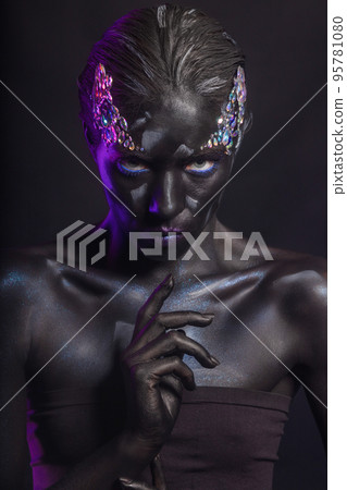 Pretty brunette with art makeup on face Pretty brunette with art makeup on face 95781080