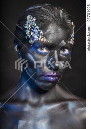 Portrait of cute woman with makeup on face Portrait of cute woman with makeup on face 95781098