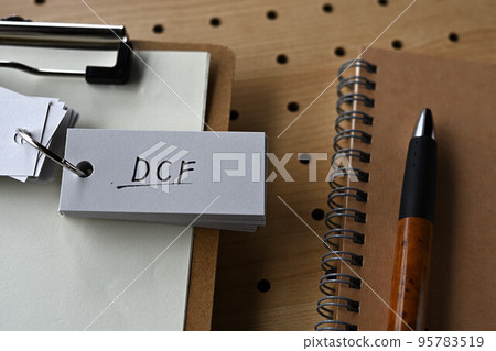 A word book with DCF characters is placed on the clipboard 95783519