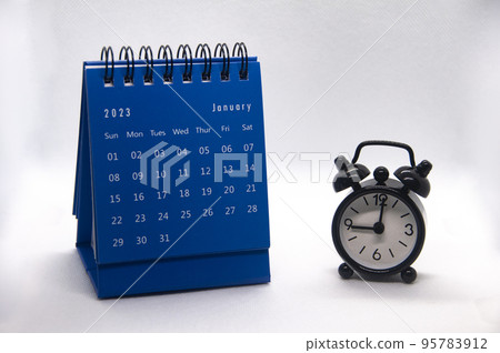 Alarm clock pointing at 9 o'clock with January 2023 calendar on white background. Time and calendar concept Alarm clock pointing at 9 o'clock with January 2023 calendar on white background. Time and calendar concept 95783912