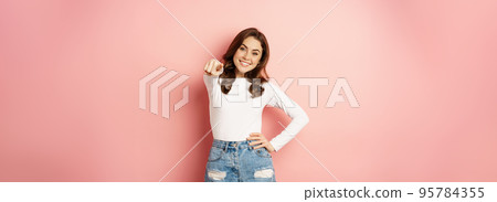 Its you, congrats. Beautiful woman with enthusiastic smile, pointing fingers at camera, congratulating, inviting people, choosing, standing over pink background 95784355