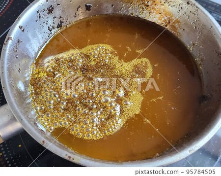 Generation of beeswax blocks Re-melting the separated beeswax in hot water over low heat Generation of beeswax blocks Re-melting the separated beeswax in hot water over low heat 95784505