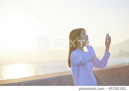 Young Japanese woman dancing while listening to music Young Japanese woman dancing while listening to music 95785181