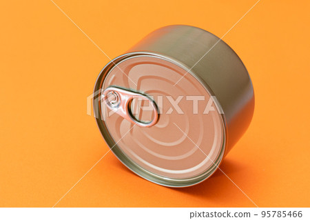 Unopened Tin Can with Blank Edge on Orange Background Unopened Tin Can with Blank Edge on Orange Background 95785466