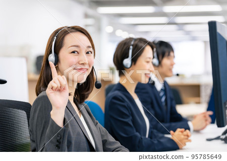 A female operator who raises her index finger 95785649