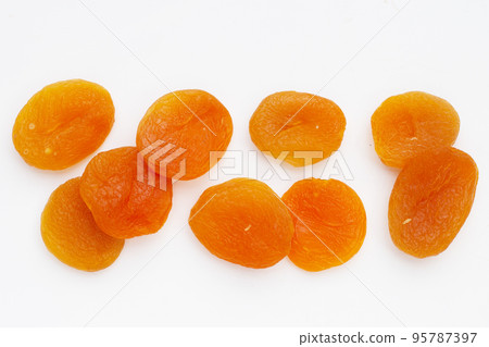 Dried apricots on white background. 95787397