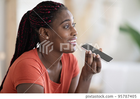 Closeup Of Happy Black Woman Recording Voice Message On Smartphone At Home Closeup Of Happy Black Woman Recording Voice Message On Smartphone At Home 95787405