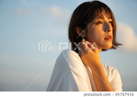 Woman portrait receiving the western sun 95787438