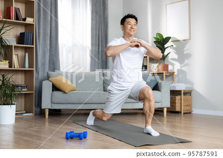 Athletic asian man training alone at home 95787591