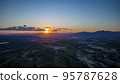 The morning sun rising over Oita City in the distance Drone distant view (1) 95787628