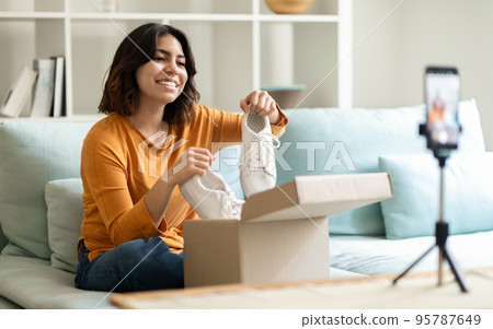 Smiling Middle Eastern Woman Recording Unboxing Video For Her Fashion Vlog 95787649
