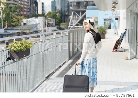 A young woman pulling a suitcase and sightseeing in Nagoya A young woman pulling a suitcase and sightseeing in Nagoya 95787661