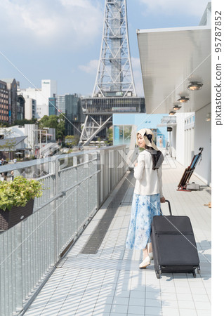 A young woman pulling a suitcase and sightseeing in Nagoya A young woman pulling a suitcase and sightseeing in Nagoya 95787852