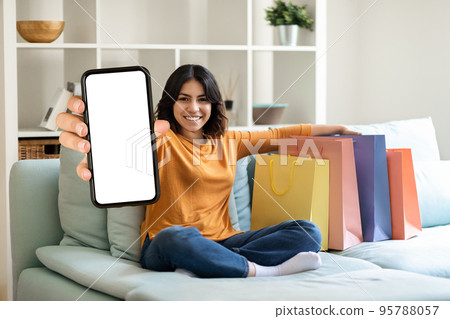 Shopping App. Cheerful Young Arab Woman Demonstrating Blank Smartphone At Camera 95788057