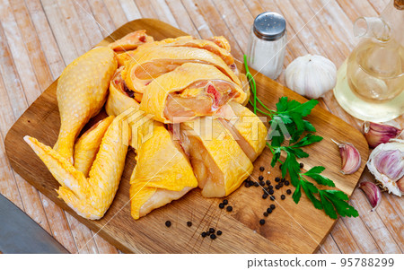 Raw sliced chicken on wooden cutting board 95788299