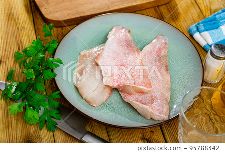 Raw rockfish fillet with condiments, cooking ingredients 95788342