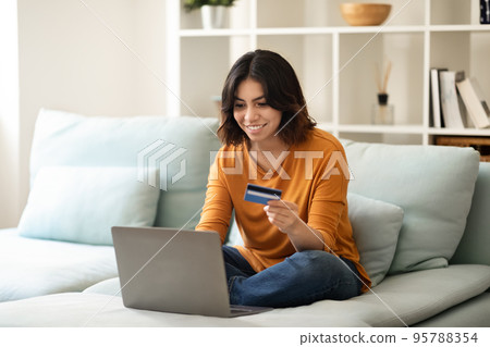 Smiling Young Arab Woman Making Online Shopping With Laptop And Credit Card 95788354