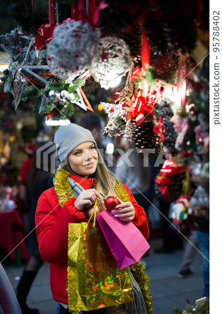Girl shopping Christmas decorations 95788402
