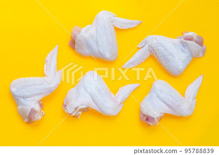 Fresh raw chicken wings on yellow background. Fresh raw chicken wings on yellow background. 95788839