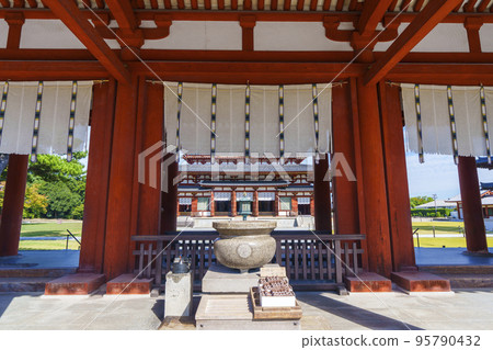 Yakushiji Chumon Gate: The beautiful Kondo Hall can be seen behind the large incense burner Yakushiji Chumon Gate: The beautiful Kondo Hall can be seen behind the large incense burner 95790432