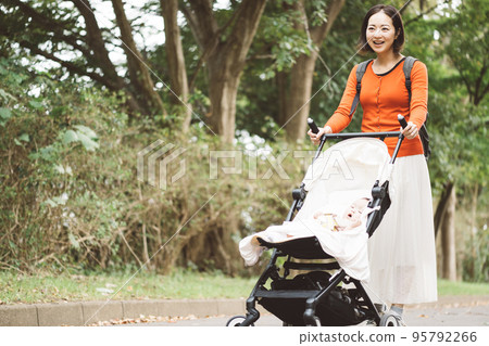 baby and mom walking with stroller baby and mom walking with stroller 95792266