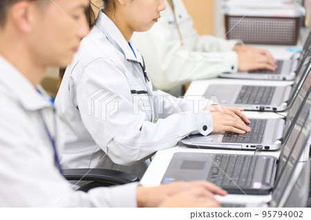 Staff working on PC kitting PC kitting setup business image 95794002