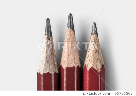 three sharpened pencils close up isolated on white background. tool for drawing, drafting and drawing up plan of action three sharpened pencils close up isolated on white background. tool for drawing, drafting and drawing up plan of action 95795502