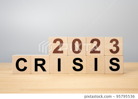 Crisis management concept in new year 2023 . Wooden cubes 2023 with text crisis. Bankruptcy and financial crisis concept. 95795536