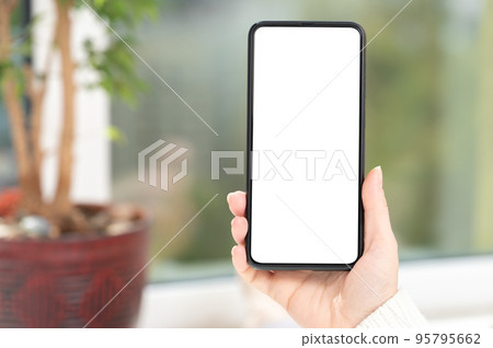 Use mobile shopping app, check social media news, texting mobile sms order food delivery sit near window at home in white clothes. Mockup cell phone. 95795662