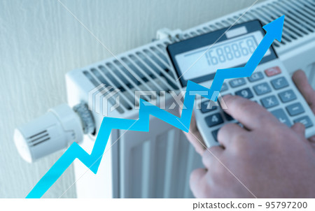 heating and energy costs rise. spend more money on heating. Expensive heating costs. hands with calculator consider cost of heating in cold season 95797200