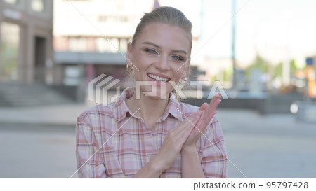 Young Woman Clapping in Appreciation Outdoor Young Woman Clapping in Appreciation Outdoor 95797428