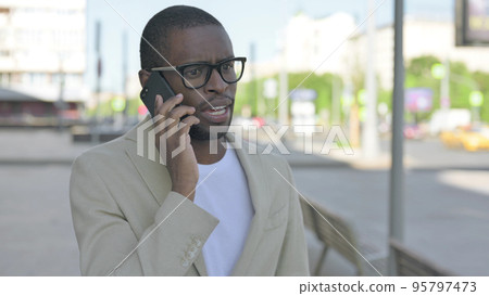 Portrait of African Man Talking on Phone Outdoor Portrait of African Man Talking on Phone Outdoor 95797473