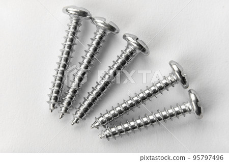 five screws on white paper. detailed macro photo. Self Tapping Screws. Set of screw five screws on white paper. detailed macro photo. Self Tapping Screws. Set of screw 95797496