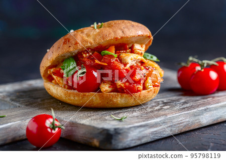 Bun stuffed with chicken and vegetables close-up. Bun stuffed with chicken and vegetables close-up. 95798119