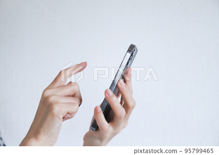 Hands for operating a smartphone 95799465