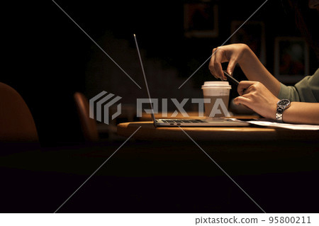 Close up hand asian woman holding pen in casual clothes working in cafe with laptop. Close up hand asian woman holding pen in casual clothes working in cafe with laptop. 95800211