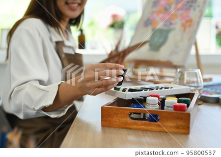 Cropped shot of young female artist choosing color for creative artwork. Art, creative hobby and leisure activity concept 95800537