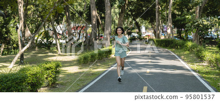 Asian woman runners. She was running on the park in the morning. banner panoramic. Asian woman runners. She was running on the park in the morning. banner panoramic. 95801537