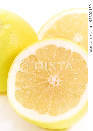 Grapefruit cut cross section yellow bright background Grapefruit cut cross section yellow bright background 95802370